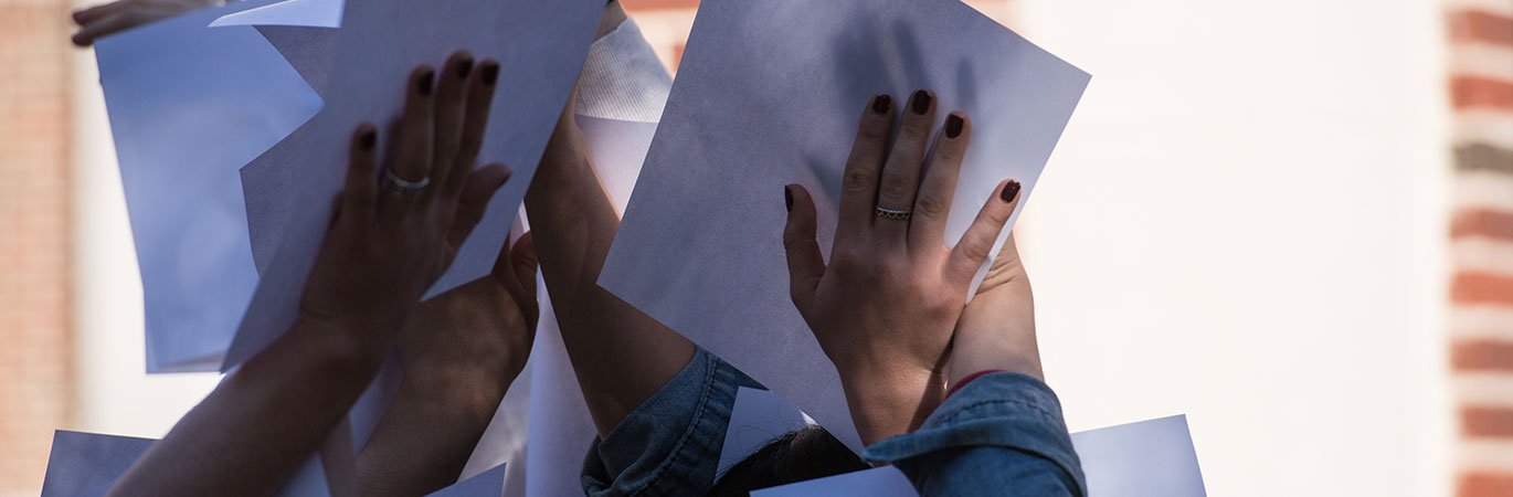 art image of students holding paper