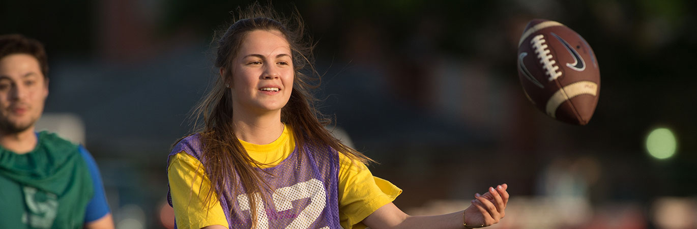 Female student catching a football