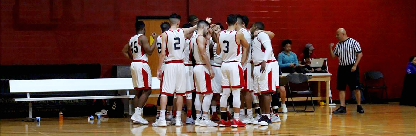 Men's Basketball players in a huddle