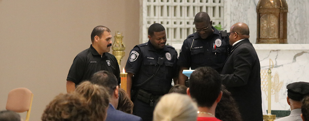 UIW police officers stand at the front of the chapel