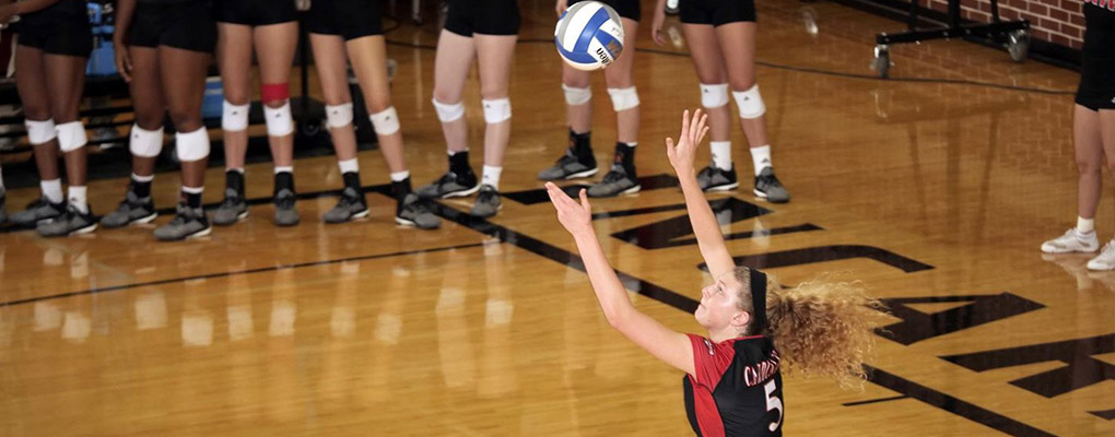 UIW volleyball player reaches for the ball during a game