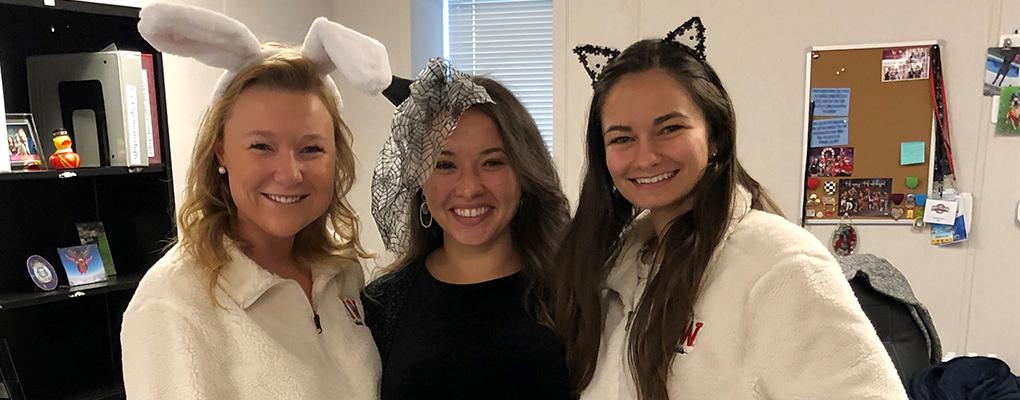 UIW community members dressed in Halloween costumes pose for a photo together