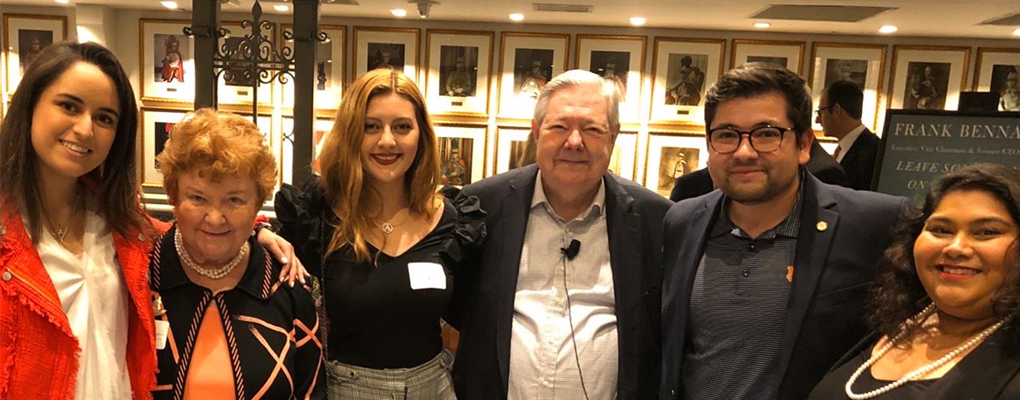 A group of people pose for a photo together at the Frank Bennack lecture