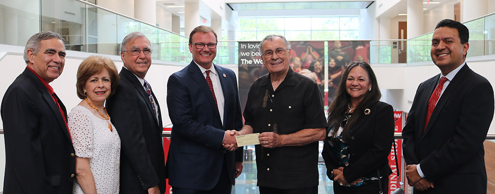 Members of Sembradores San Antonio and UIW pose for a photo together with a check donation 