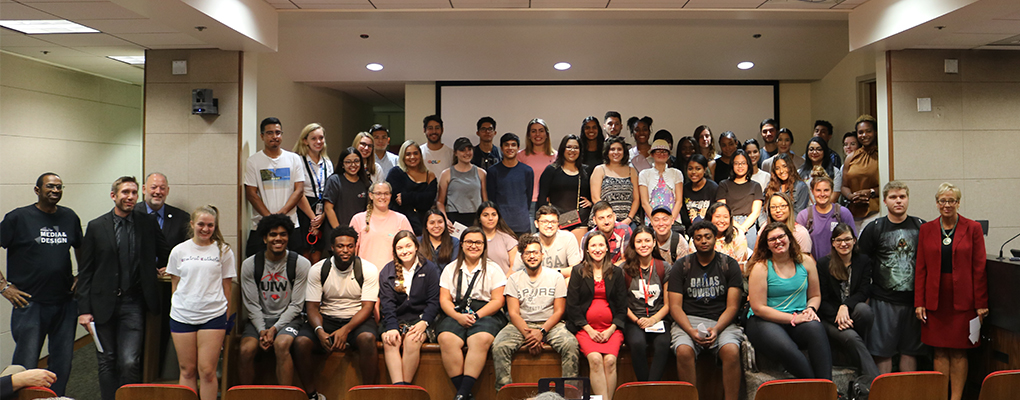 Students gather for a photo and smile at the camera with UIW faculty and Emma Cantu