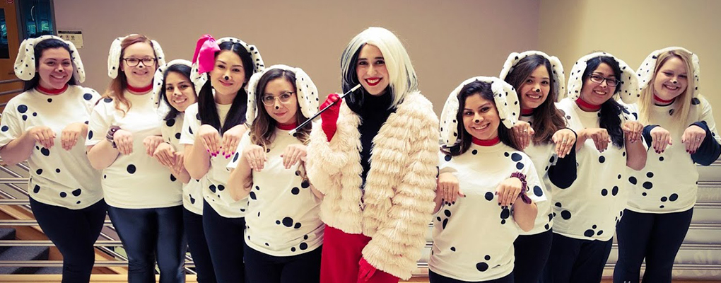 UIW community members dressed in Halloween costumes pose for a photo together