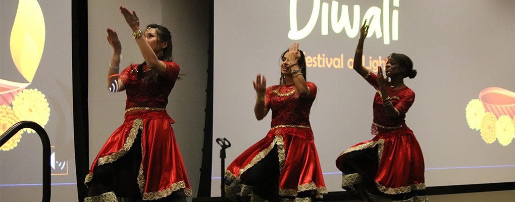 Three women dance on stage