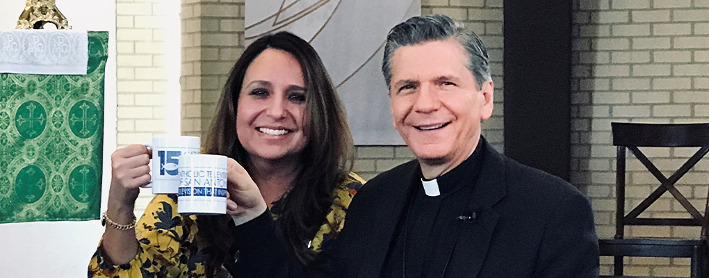 Dr. Kristina Vidaurri and Archbishop Gustavo pose for a photo while holding up coffee mugs