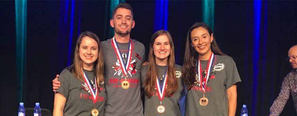 The Eyevengers team poses for a photo with medals around their necks