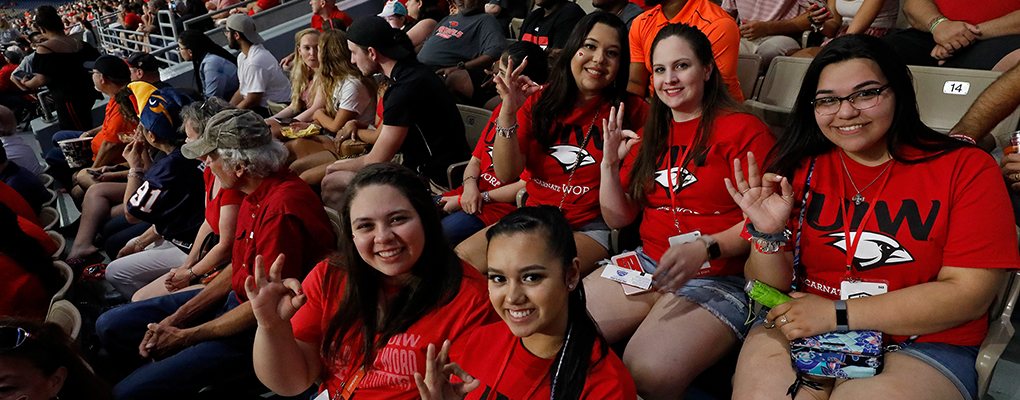 UIW fans sit and smile at the camera