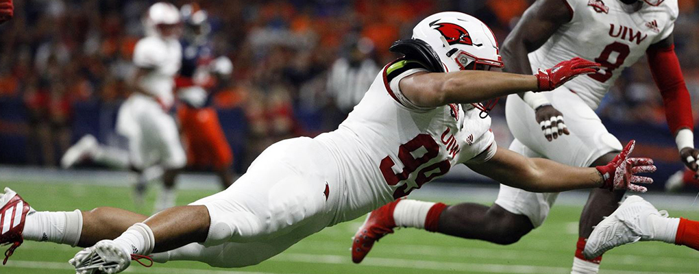 A UIW football player dives on the field to attempt a tackle