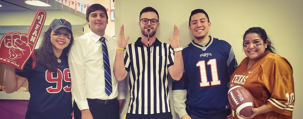 UIW community members dressed in Halloween costumes pose for a photo together