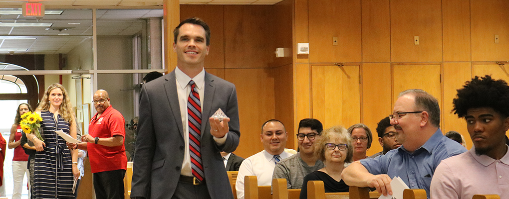 A UIW professor walks to the front of the chapel