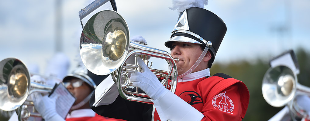 UIW Marching Cardinals members performs at a football game