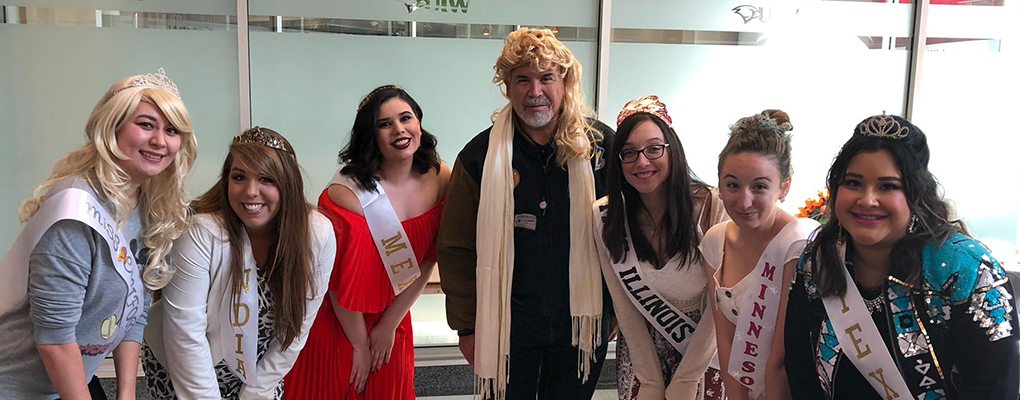 UIW community members dressed in Halloween costumes pose for a photo together