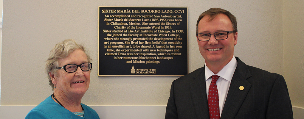 Dr. Evans and Sr. Stanley stand in front of commemorative plaque