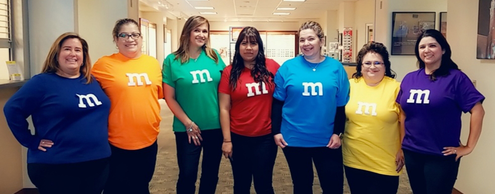 UIW community members dressed in Halloween costumes pose for a photo together