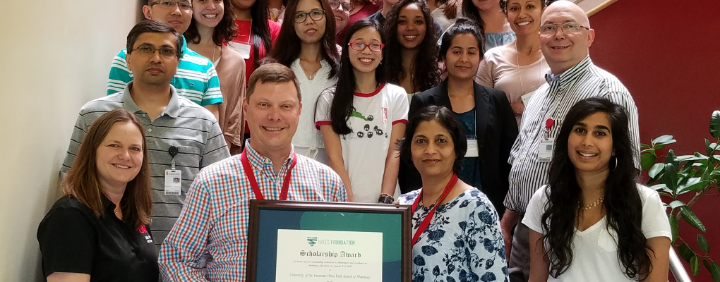 Dr. Maize (left) and Dr. Ramsinghani (right), holding the grant program certificate from NACDS.  