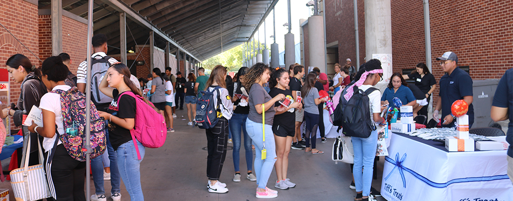 A crowd of people visit various informational tables