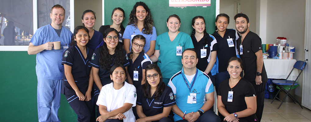 UIW volunteers wearing scrubs pose for a group photo