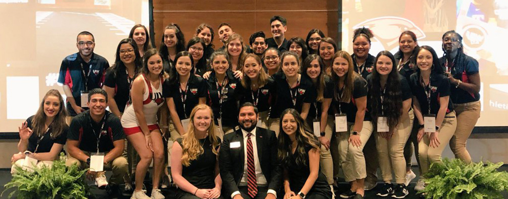 UIW's orientation staff poses for a photo on stage