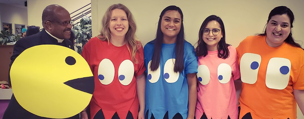 UIW community members dressed in Halloween costumes pose for a photo together