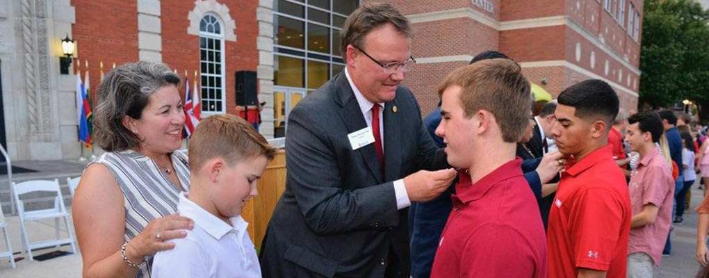 Dr. Evans presents his son with a pin at Pinning Ceremony