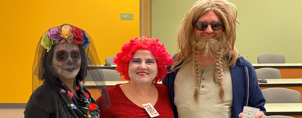 UIW community members dressed in Halloween costumes pose for a photo together