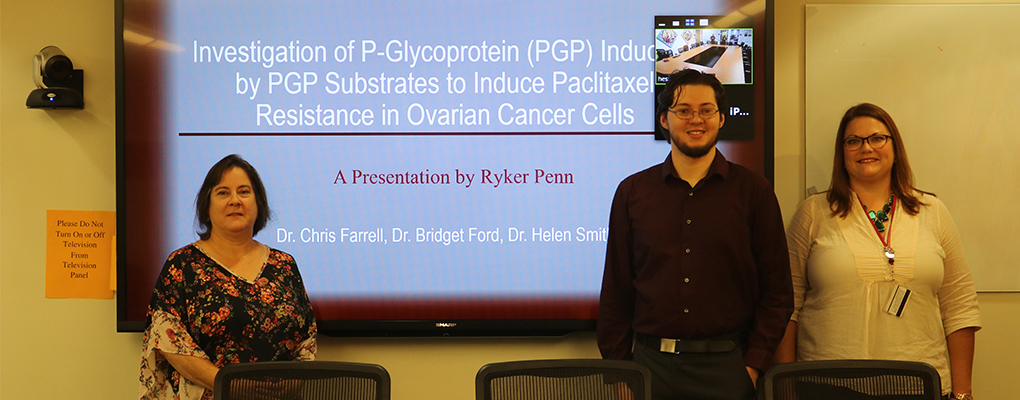 Ryker Penn poses for a photo at his thesis defense