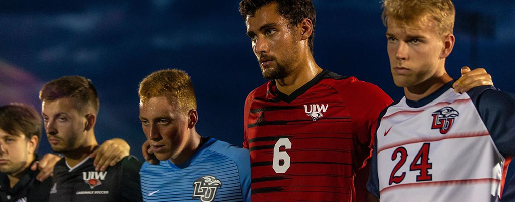 UIW men's soccer players stand on the field side by side with Lamar University players