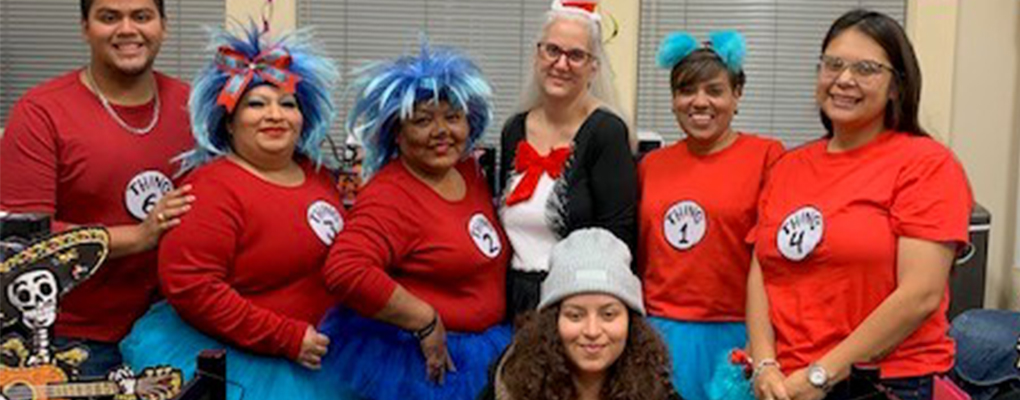 UIW community members dressed in Halloween costumes pose for a photo together