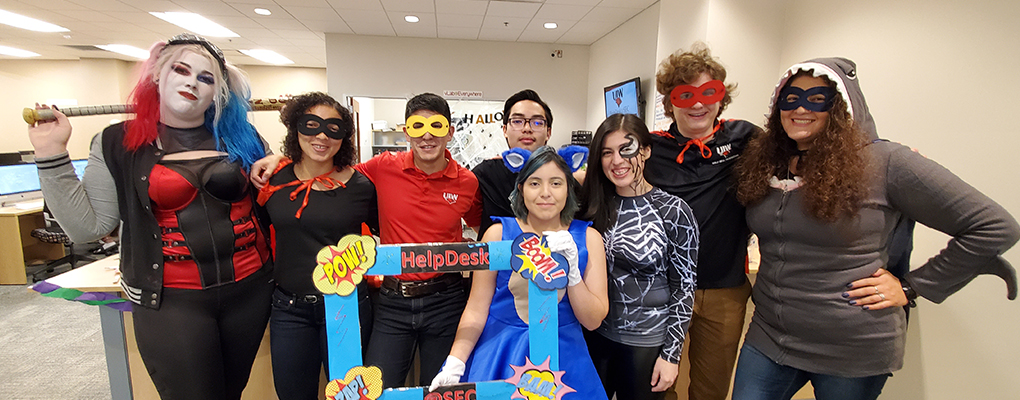 UIW community members dressed in Halloween costumes pose for a photo together