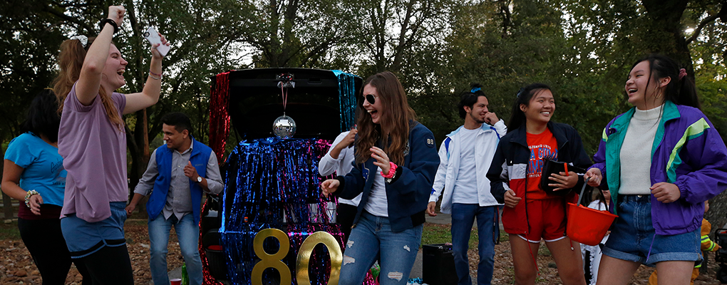 UIW students dressed as people from the 1980s dance outside