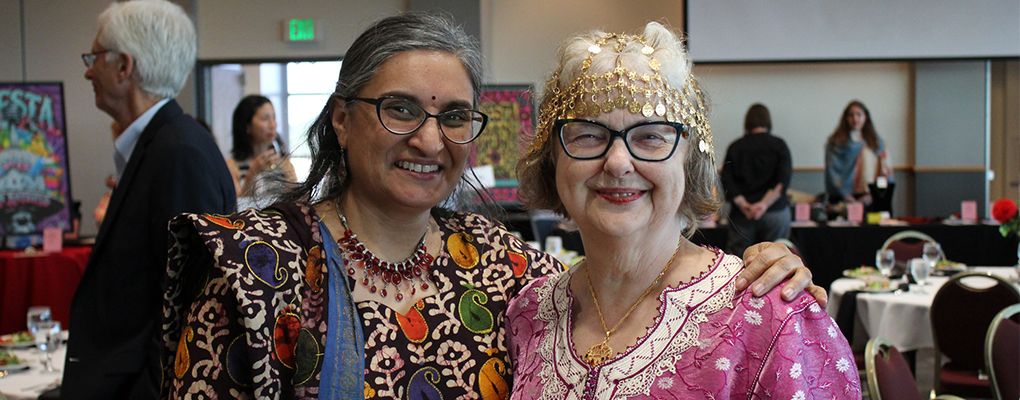 Two gala attendees pose for a photo and smile at the camera