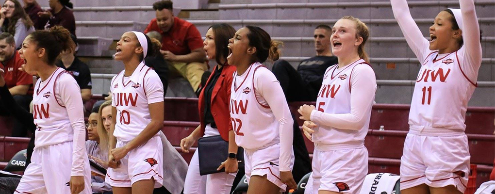UIW women's baskeball team cheers from the sidelines