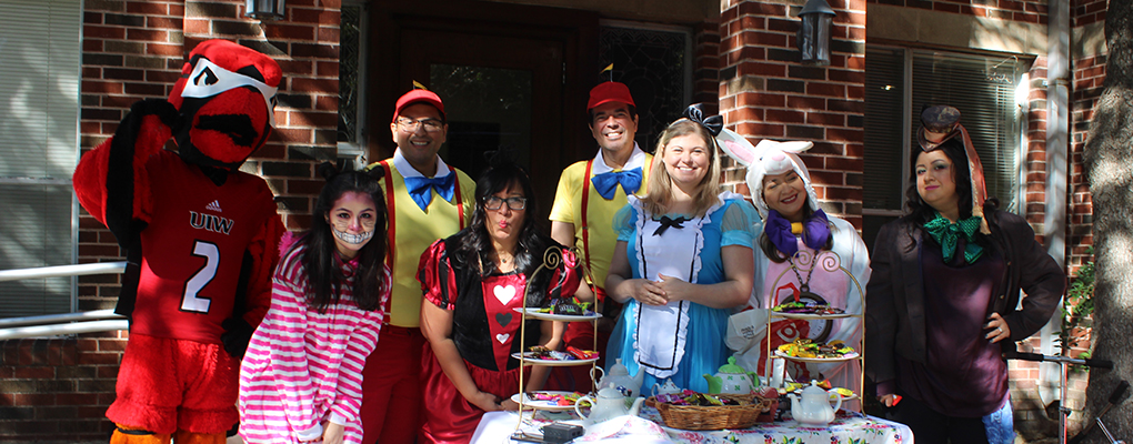 UIW employees dressed as characters from Alice in Wonderland pose for a photo