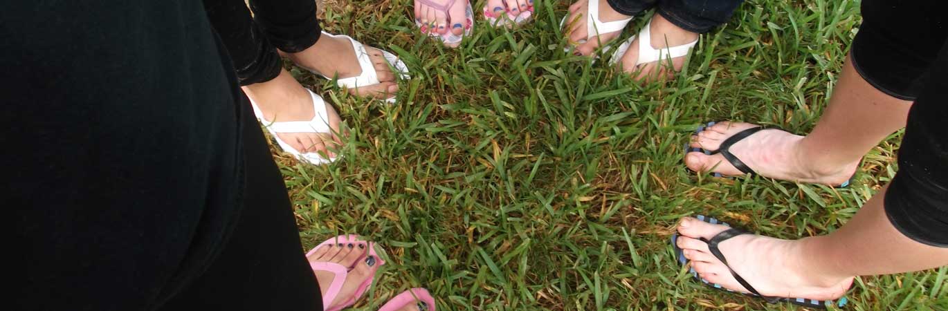 Feet in a circle on grass
