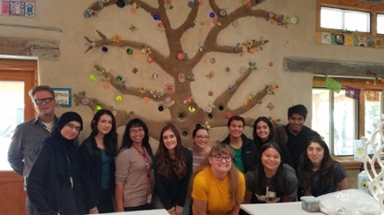 Picture of students in front of tree painting