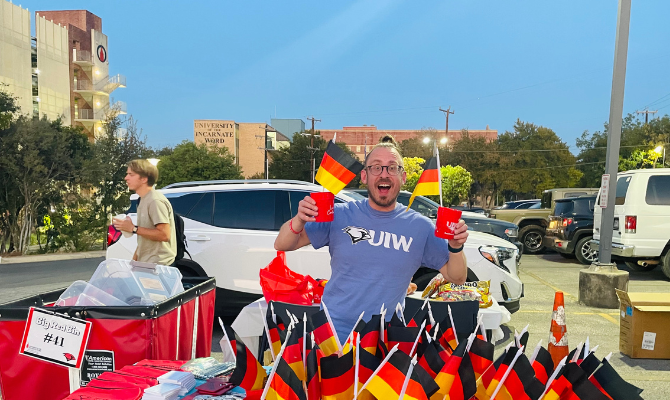 Housing staffer passing out German flags at Octoberfest