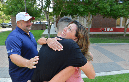 Parent hugging student goodbye