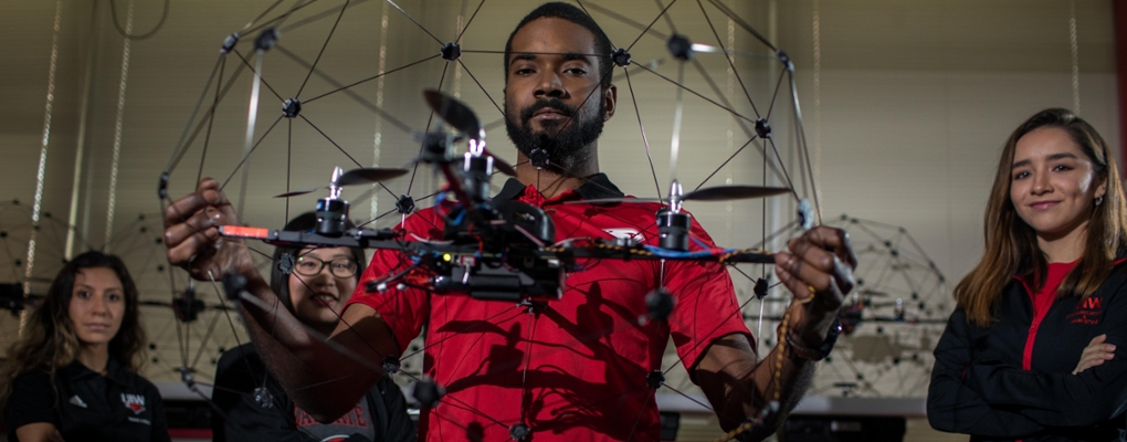 UIW students pose with a drone