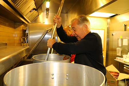 dr. agnese stirs spaghetti sauce for 2015 president's spaghetti dinner