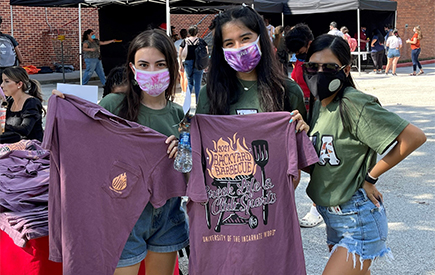 Students pose displaying T-shirts