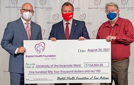 Three men hold a large check
