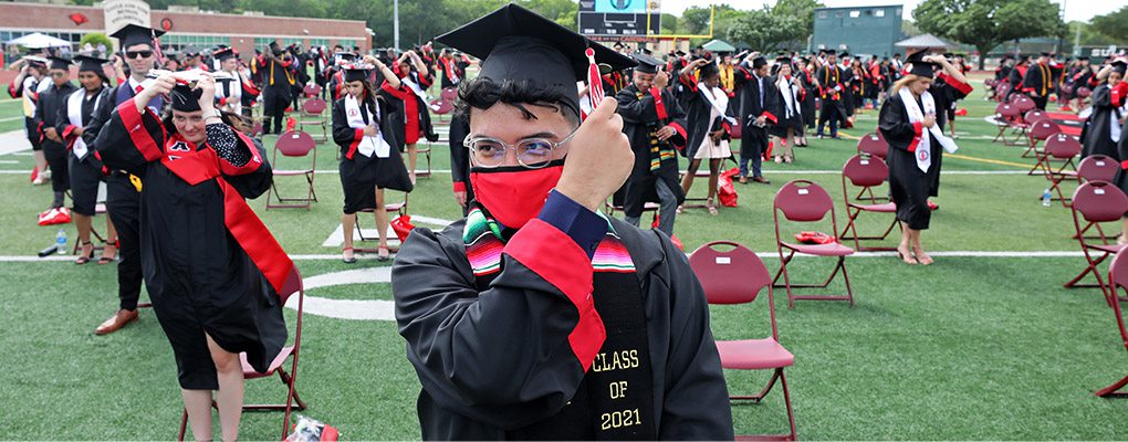 A graduate moving his tassle to the right
