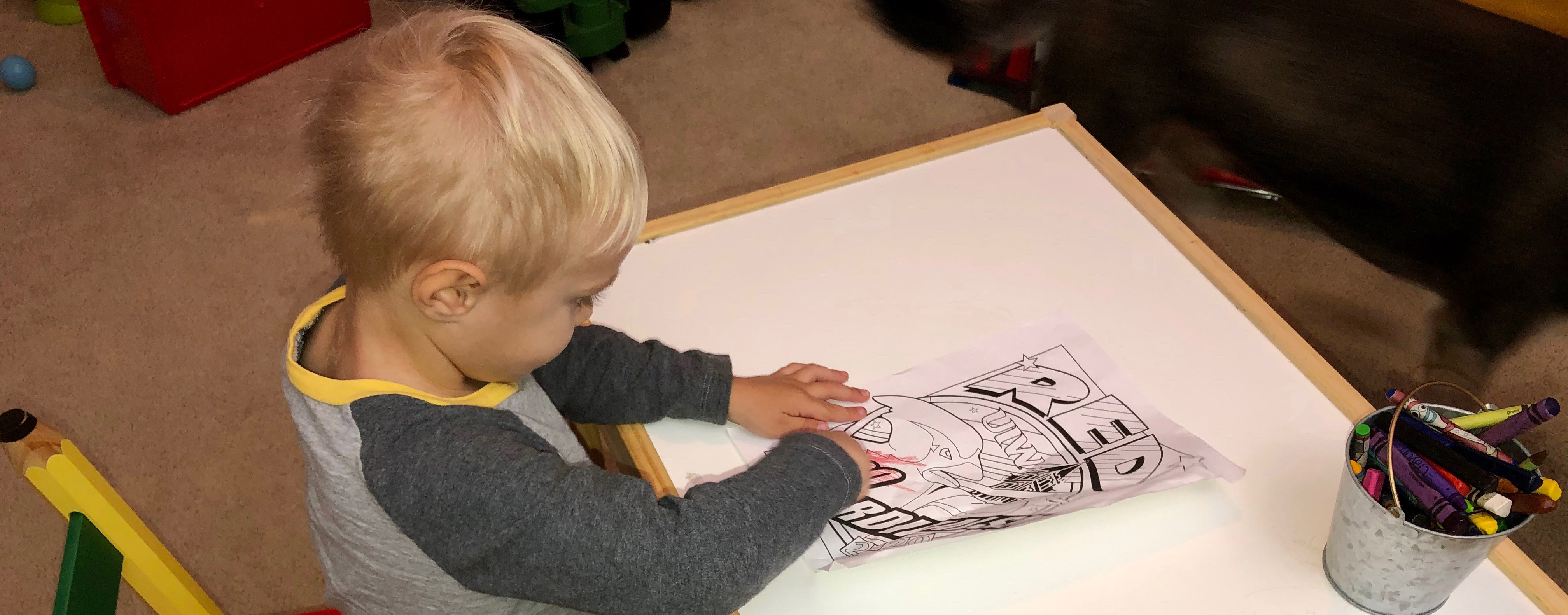 A child colors a picture