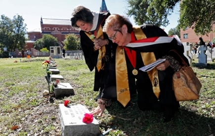 Two women visit a burial site 