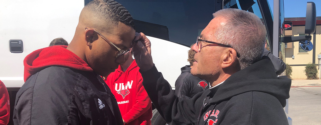 A student receives a blessing of ashes on his forehead