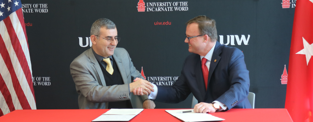 President Evans shakes hands with Ataturk representative 