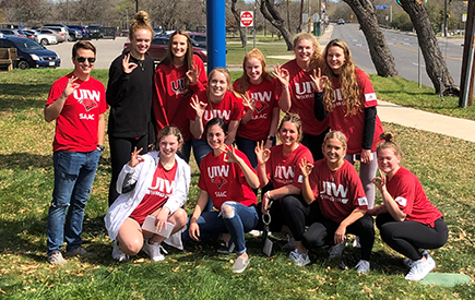 A group of student-athletes pose for a photo together